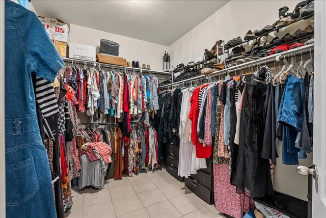 a view of walk in closet with clothes