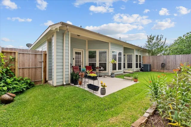 a view of a house with backyard porch and sitting area