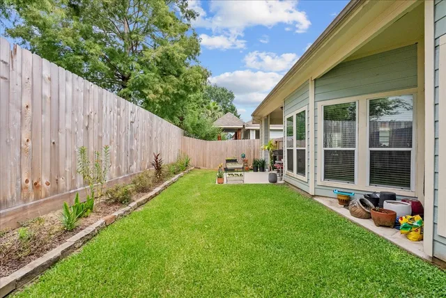 a view of a chair and table in backyard of the house