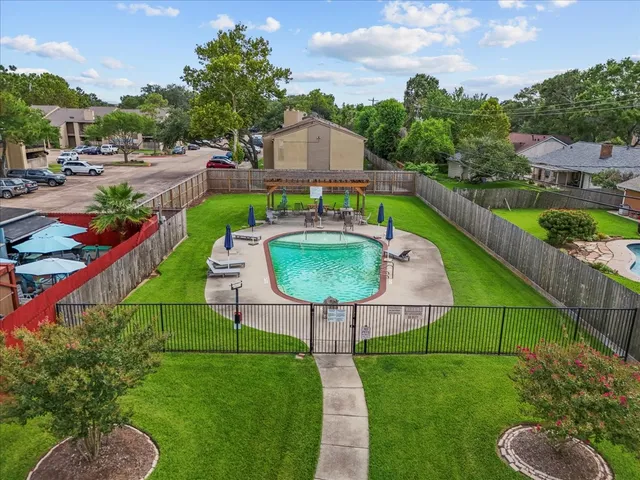 a view of a swimming pool with a garden and plants