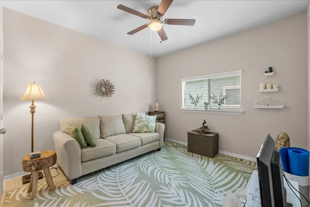 a living room with furniture and a lamp