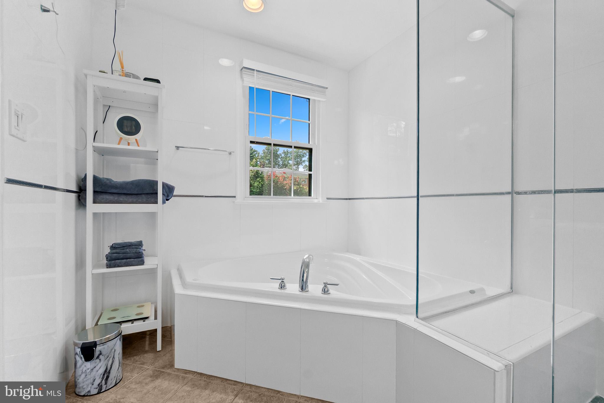 2003 Forest Dale Drive Silver Spring, MD 20903 - Photo 16 of 44 a bathroom with a bathtub and a window