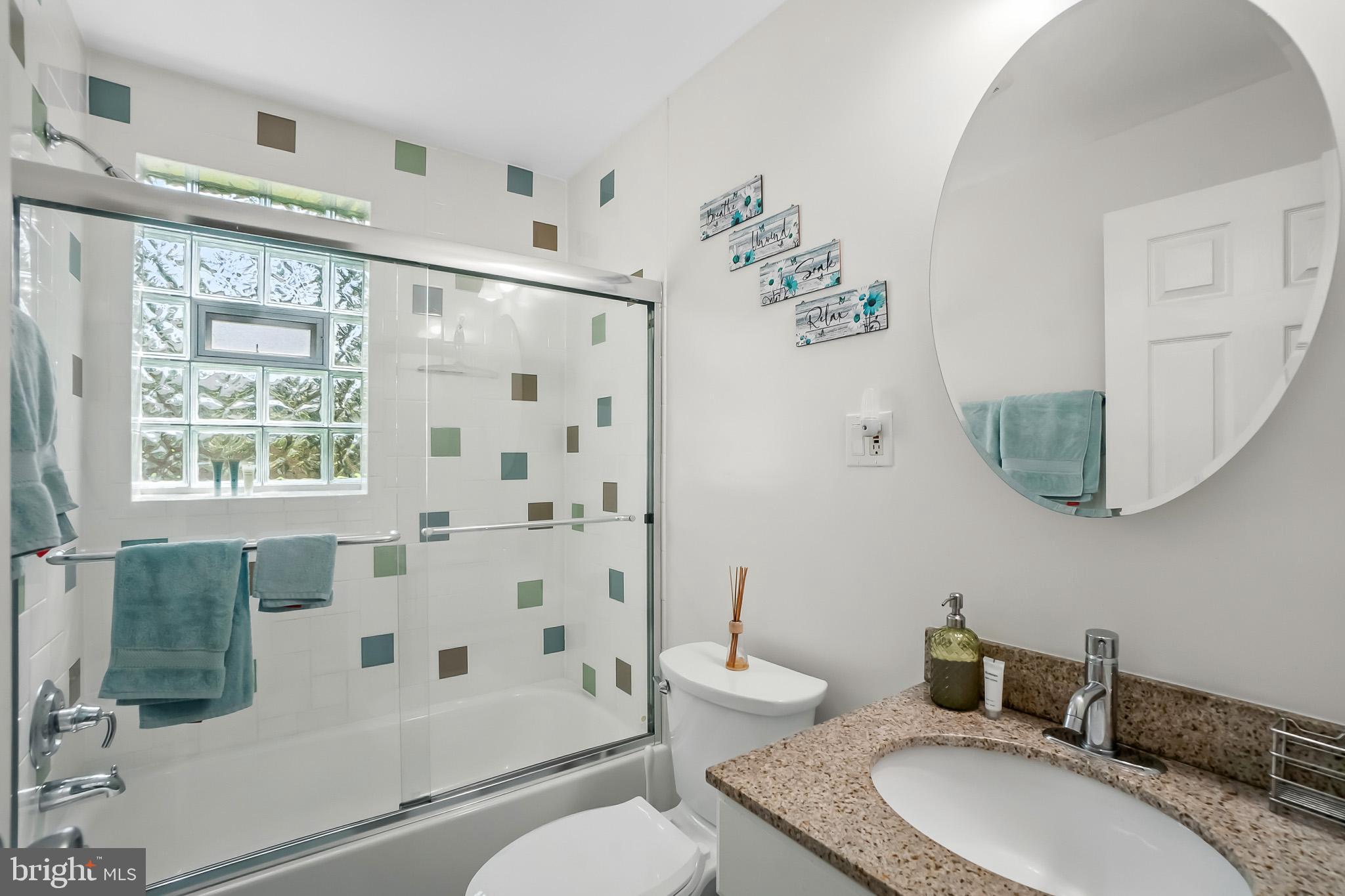 2003 Forest Dale Drive Silver Spring, MD 20903 - Photo 22 of 44 a bathroom with a granite countertop toilet sink and mirror