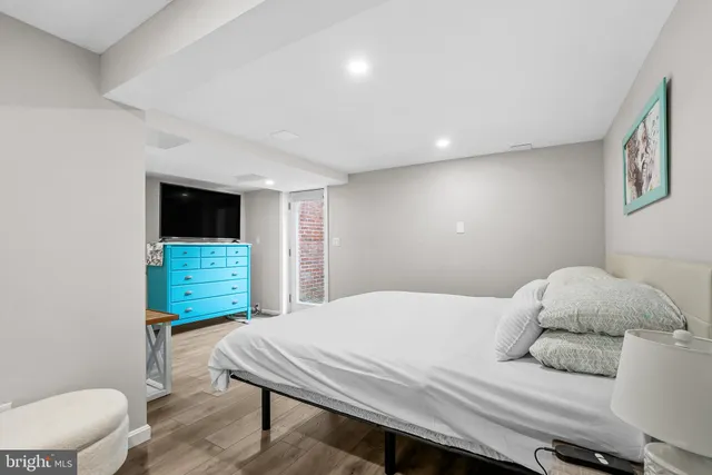 a bedroom with a bed and a television