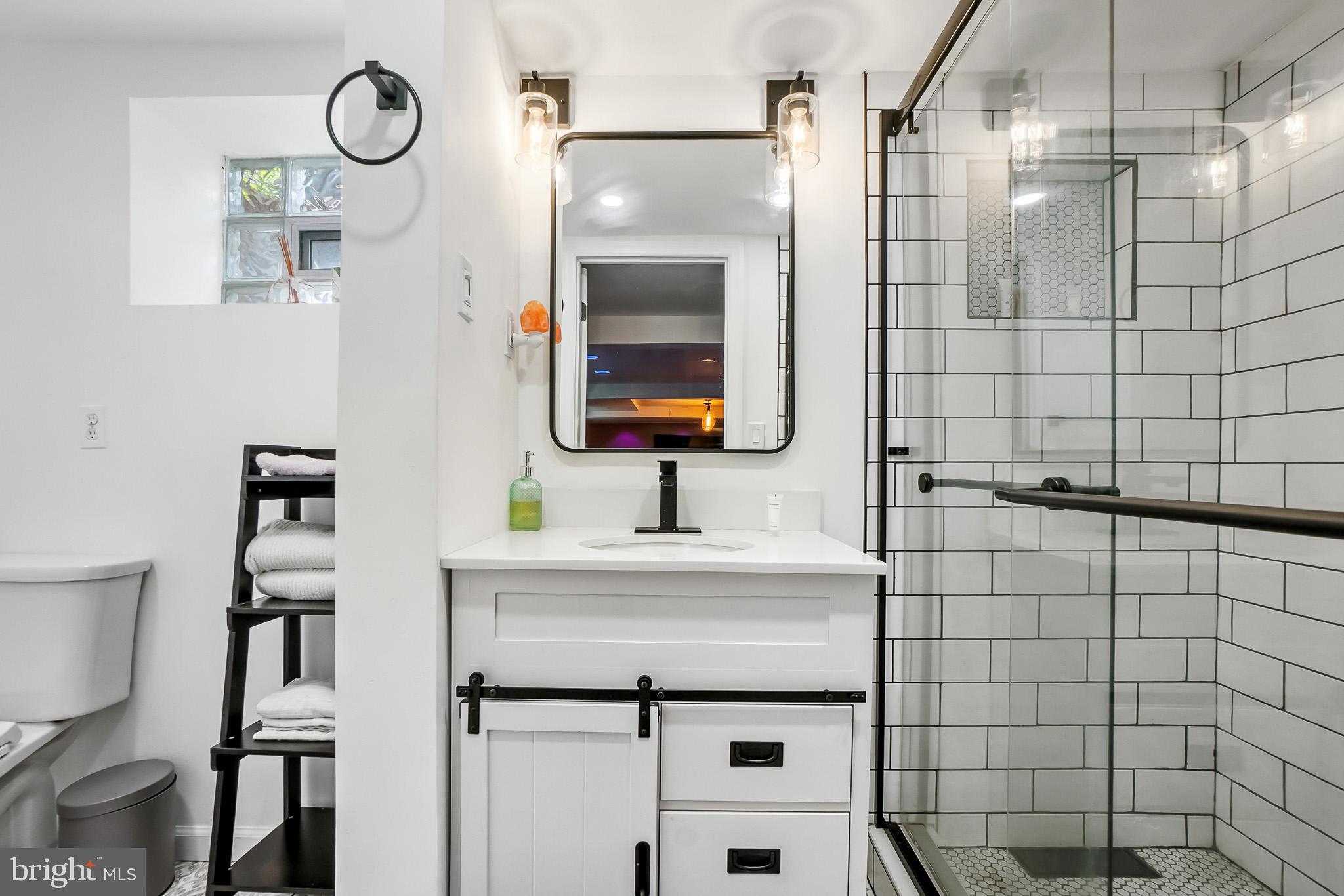 2003 Forest Dale Drive Silver Spring, MD 20903 - Photo 27 of 44 a bathroom with a sink toilet and mirror