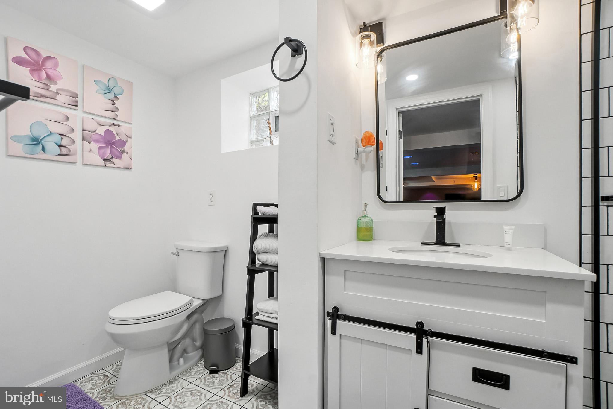 2003 Forest Dale Drive Silver Spring, MD 20903 - Photo 28 of 44 a bathroom with a toilet sink and mirror