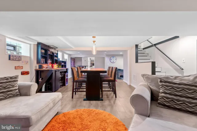 a living room with furniture a chandelier and a dining table