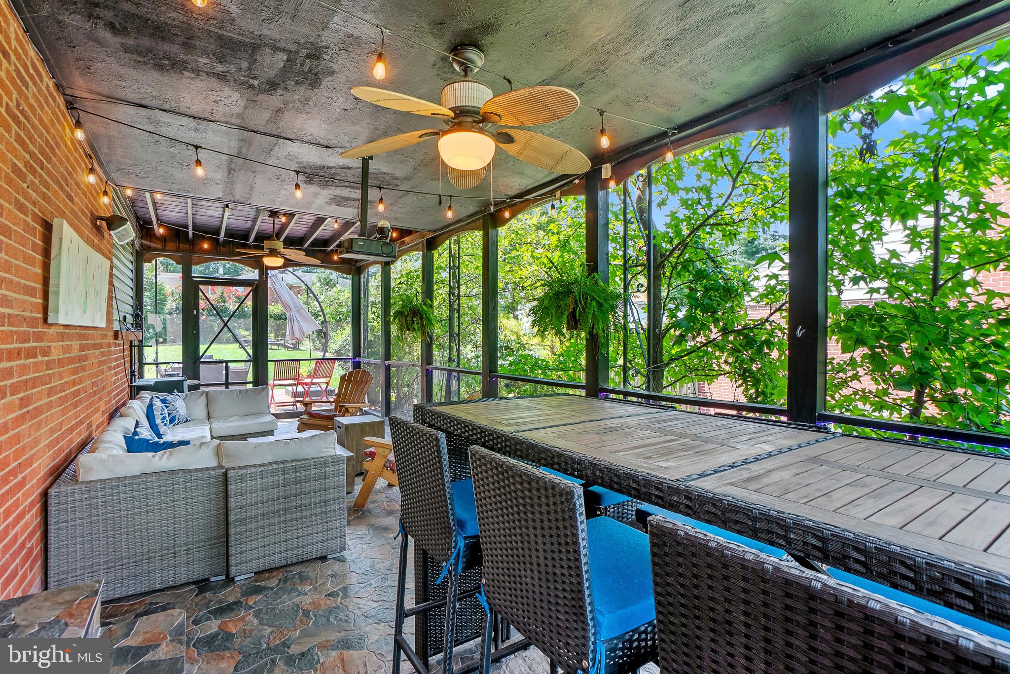 2003 Forest Dale Drive Silver Spring, MD 20903 - Photo 36 of 44 a view of a patio with table and chairs potted plants with wooden floor and fence