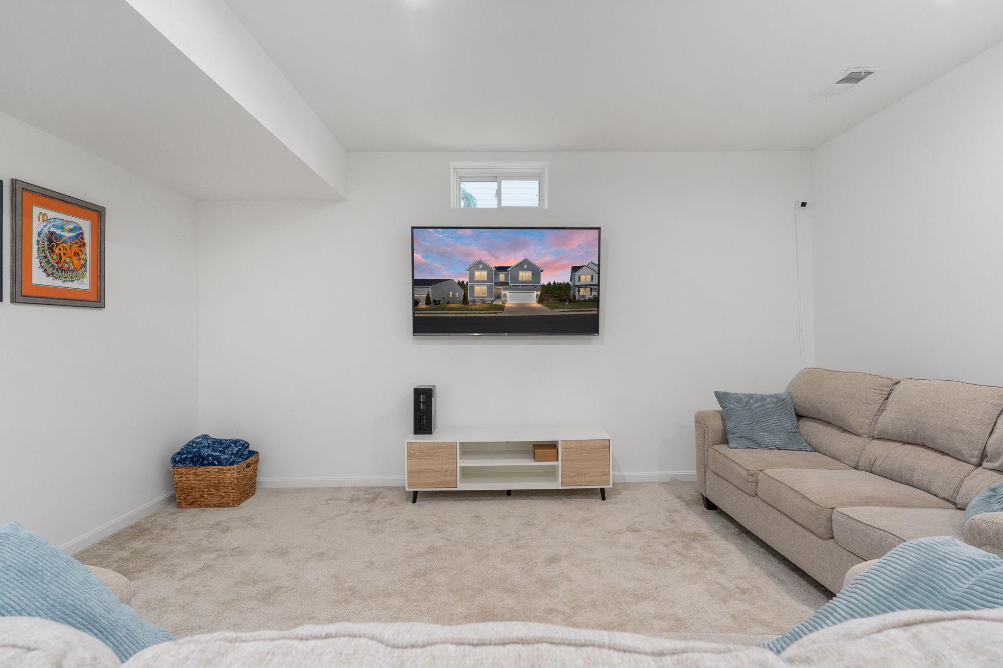6371 Pointer Lane King George, VA 22485 - Photo 29 of 38 a living room with furniture and a flat screen tv