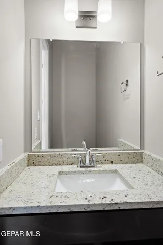 a view of bathroom with granite countertop