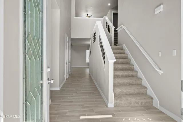 a view of a hallway with wooden floor and entryway
