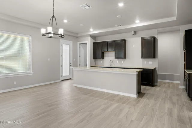 a view of kitchen with granite countertop cabinets and stainless steel appliances