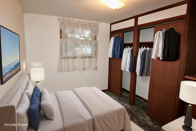 a bedroom with a large bed and a window