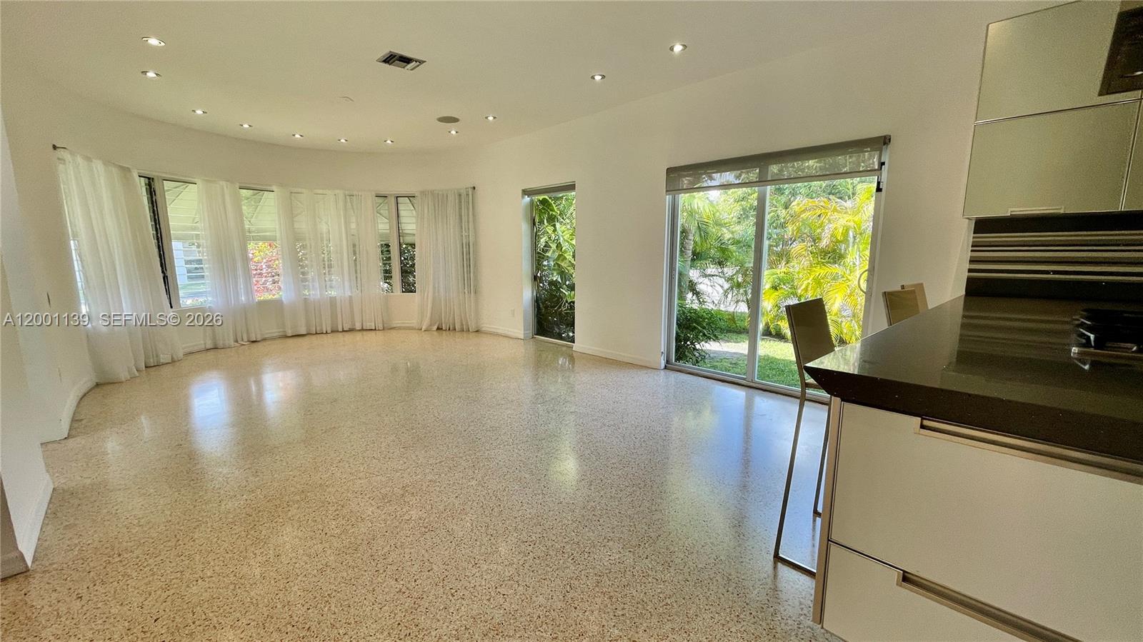 625 93rd Street Surfside, FL 33154 - Photo 17 of 50 a view of an empty room with wooden floor and a window