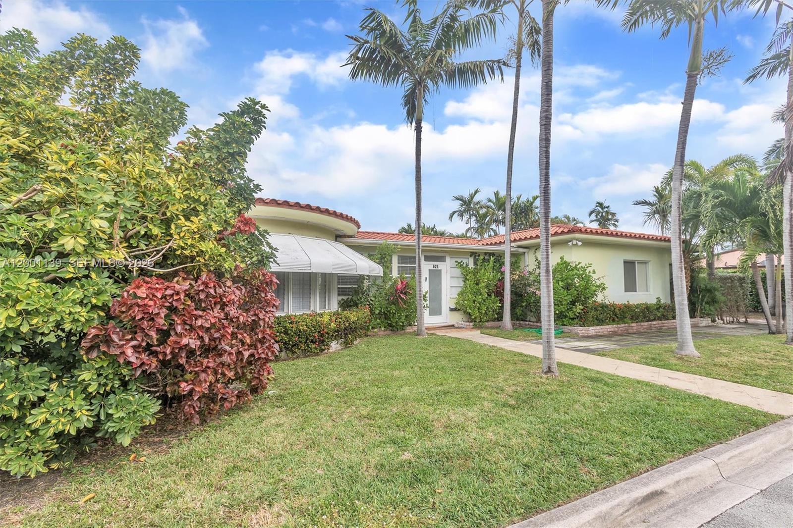 625 93rd Street Surfside, FL 33154 - Photo 2 of 50 a view of a house with backyard and a garden