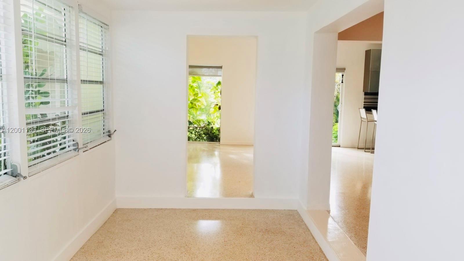 625 93rd Street Surfside, FL 33154 - Photo 27 of 50 a view of a hallway with wooden floor and a dining room