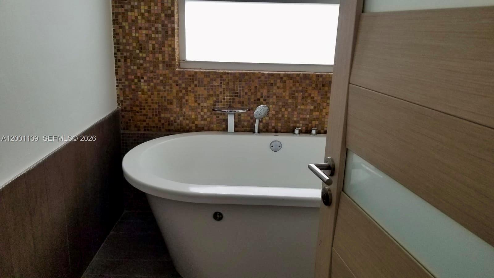 625 93rd Street Surfside, FL 33154 - Photo 28 of 50 a bathroom with a bathtub