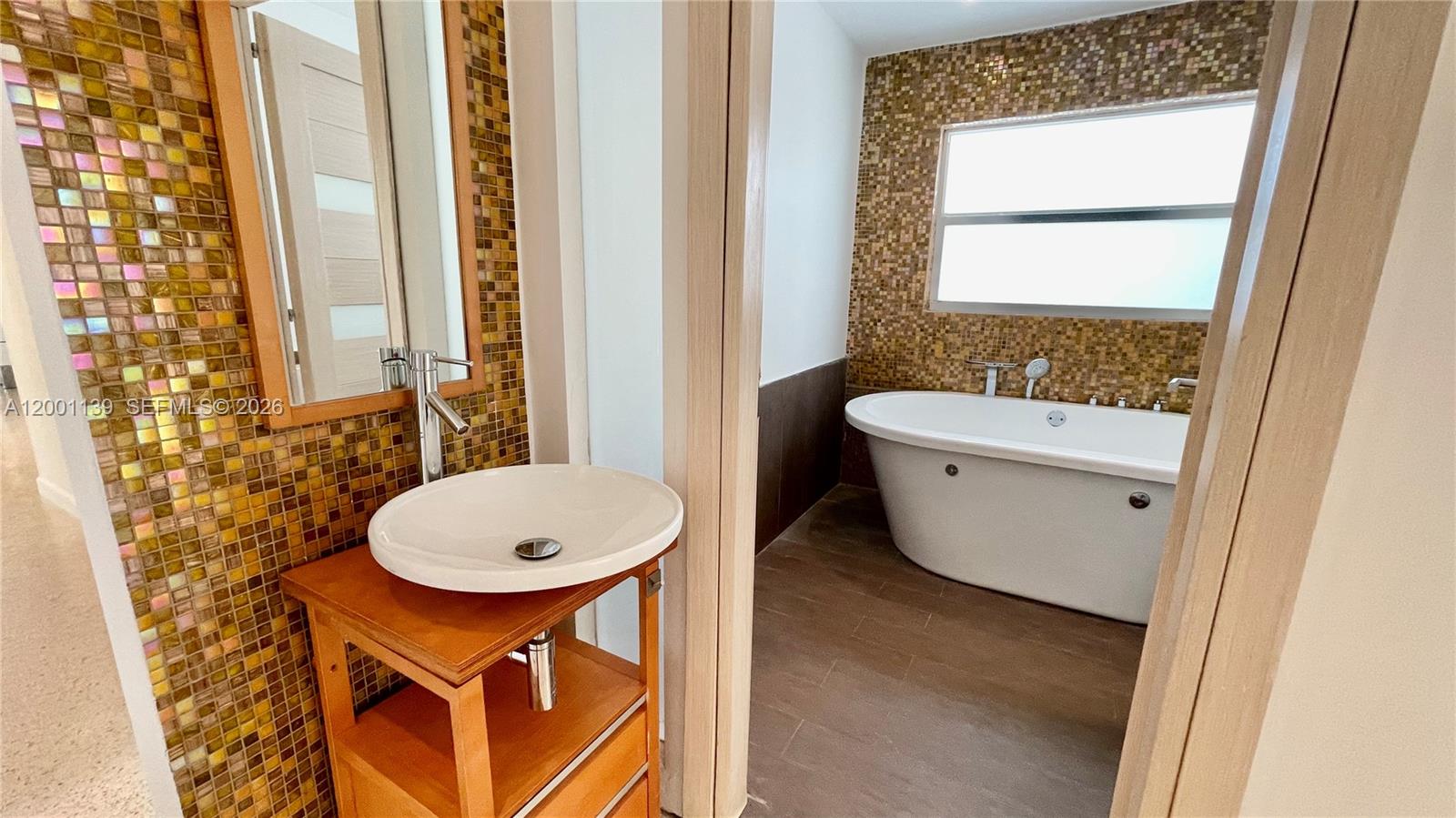 625 93rd Street Surfside, FL 33154 - Photo 33 of 50 a bathroom with a toilet a sink and a mirror