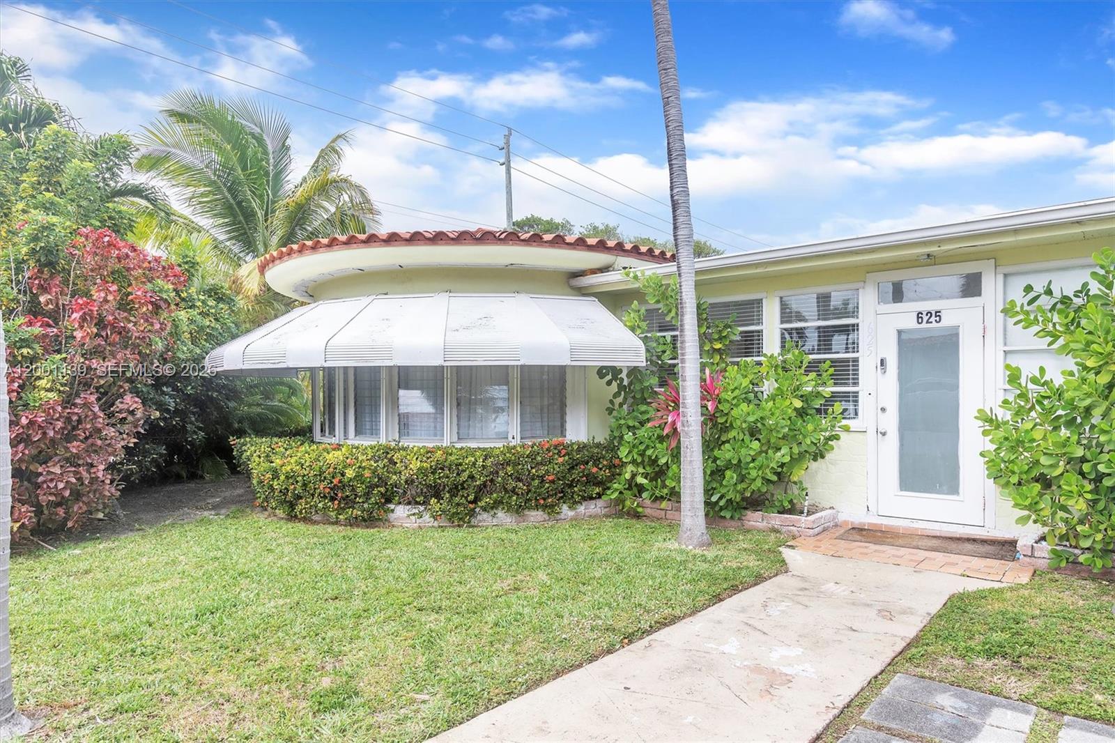 625 93rd Street Surfside, FL 33154 - Photo 5 of 50 a front view of a house with garden