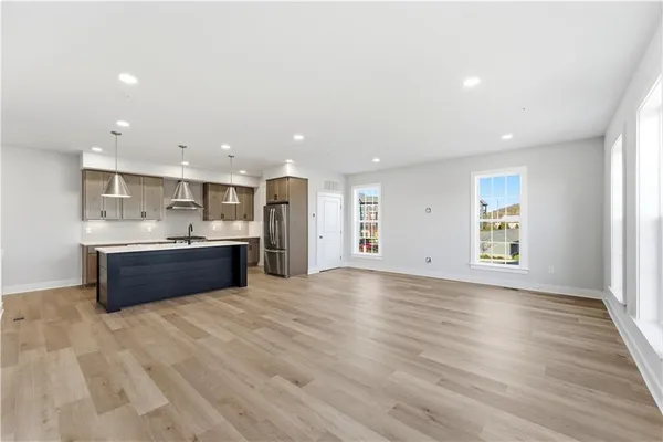a large kitchen with stainless steel appliances granite countertop a large counter top a sink and dishwasher