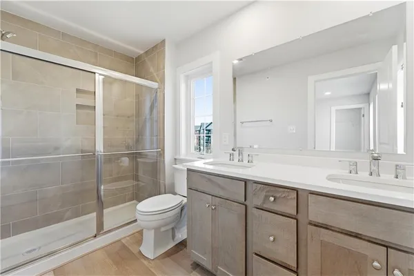 a bathroom with a sink toilet and shower