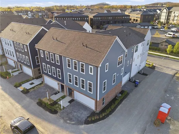 an aerial view of a houses with a city view