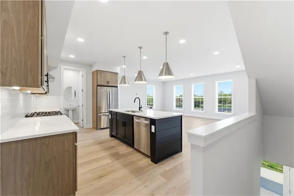 a large kitchen with a large counter top appliances and cabinets