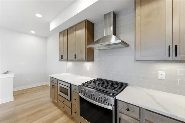 a kitchen with granite countertop a stove and a sink