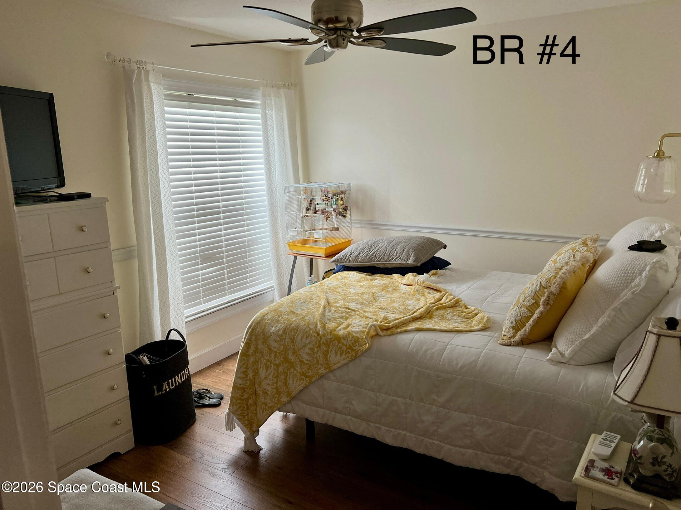 4130 Orion Way Rockledge, FL 32955 - Photo 4 of 14 a bedroom with a bed and a window