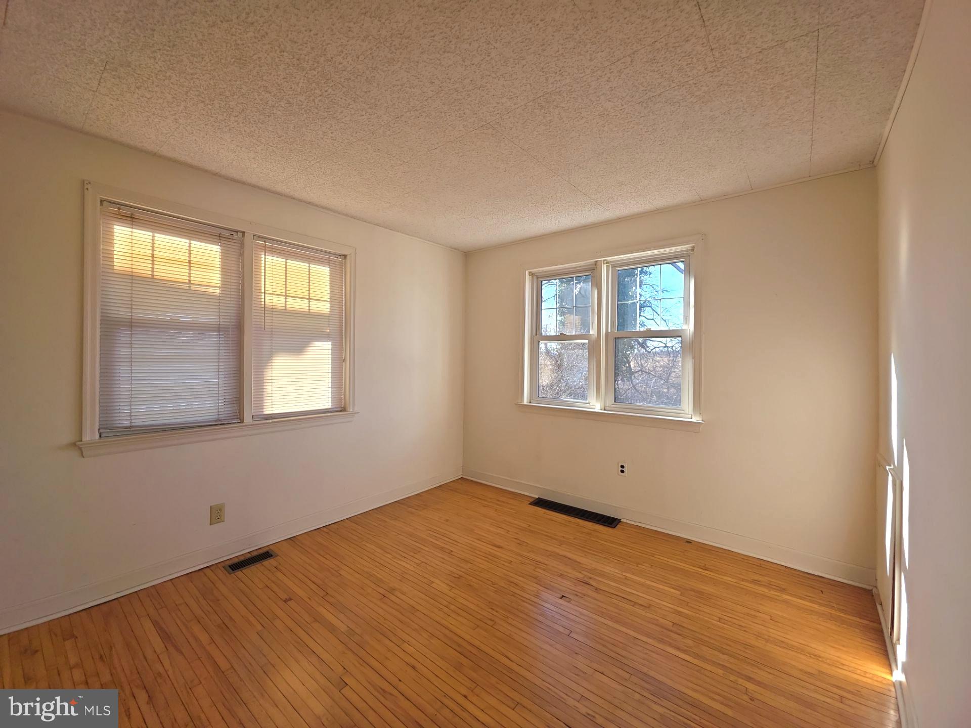 167 Singley Avenue Runnemede, NJ 08078 - Photo 27 of 56 a view of an empty room with wooden floor and a window