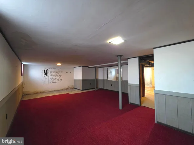 a view of empty room with wooden ceiling