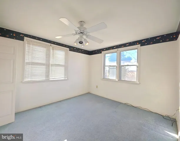 an empty room with a empty space and windows