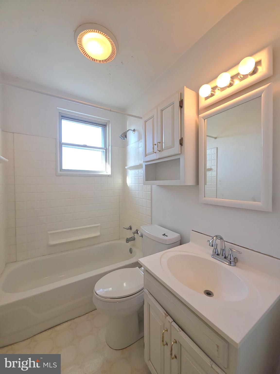 167 Singley Avenue Runnemede, NJ 08078 - Photo 44 of 56 a bathroom with a toilet a sink a tub and a mirror
