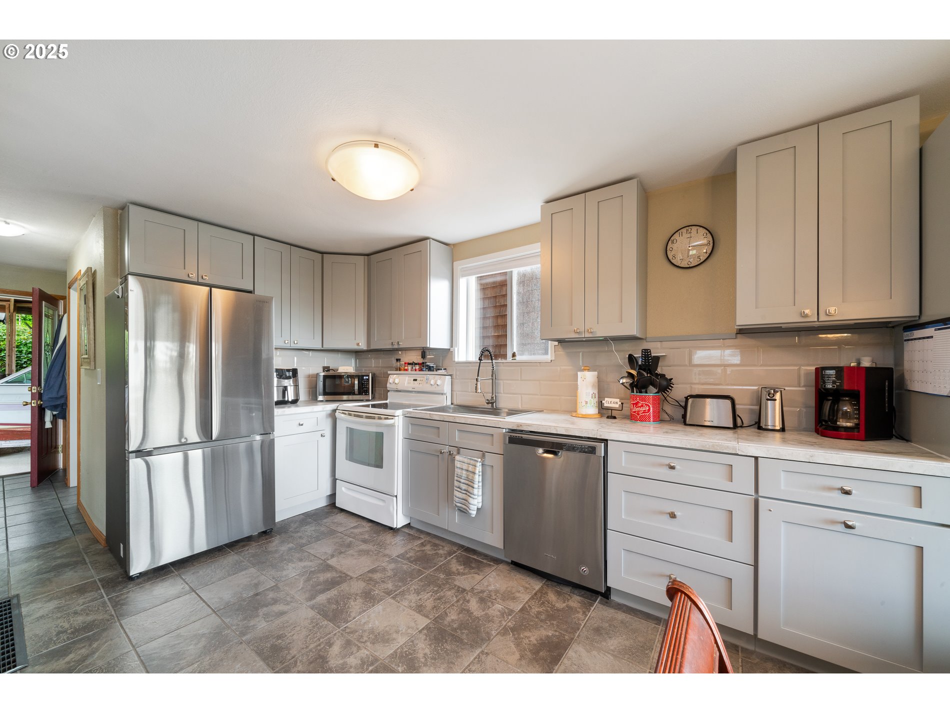 336 Gregory Street Wheeler, OR 97147 - Photo 11 of 42 a kitchen with white cabinets and stainless steel appliances