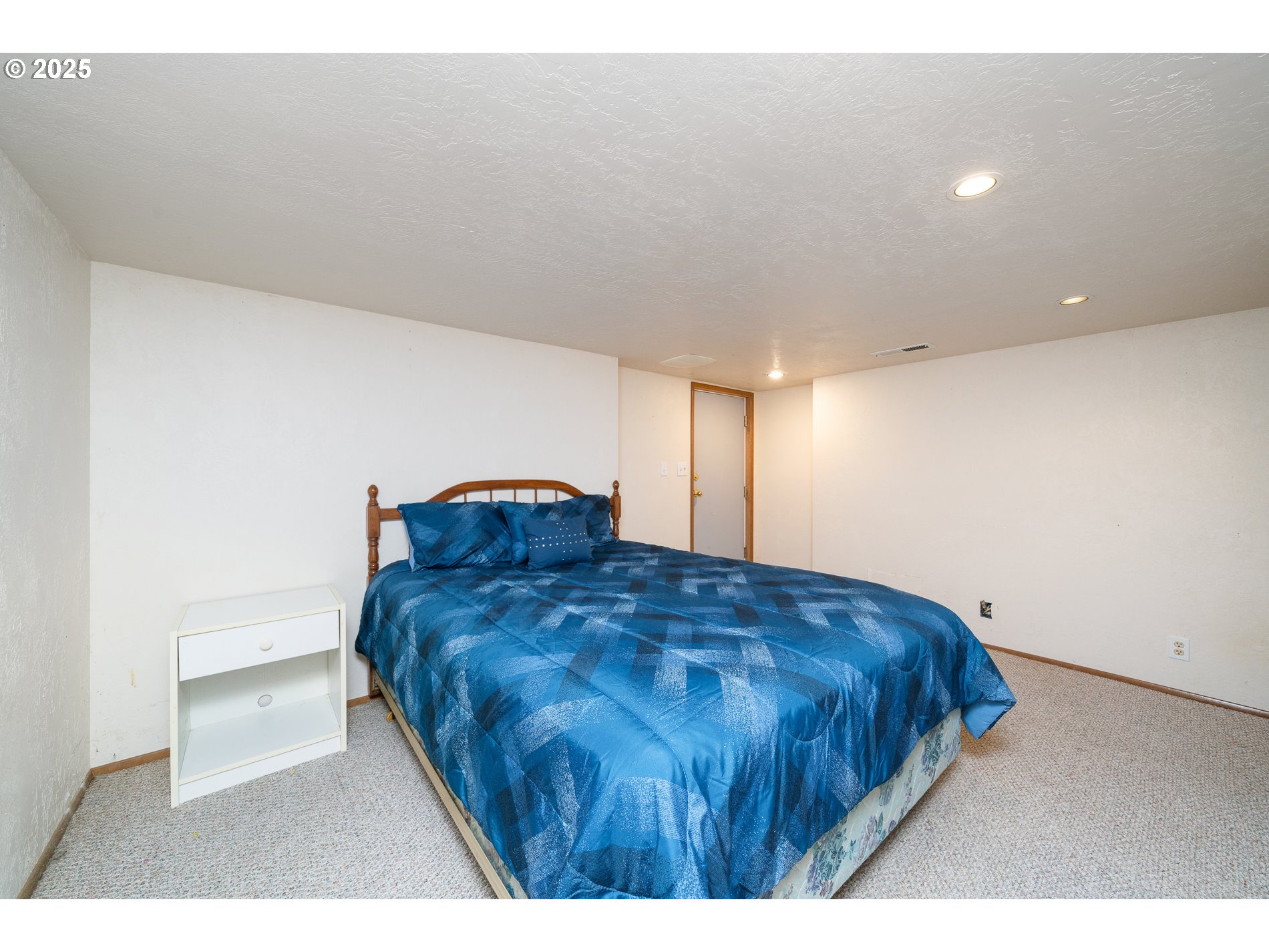 336 Gregory Street Wheeler, OR 97147 - Photo 30 of 42 a bedroom with a bed and a lamp