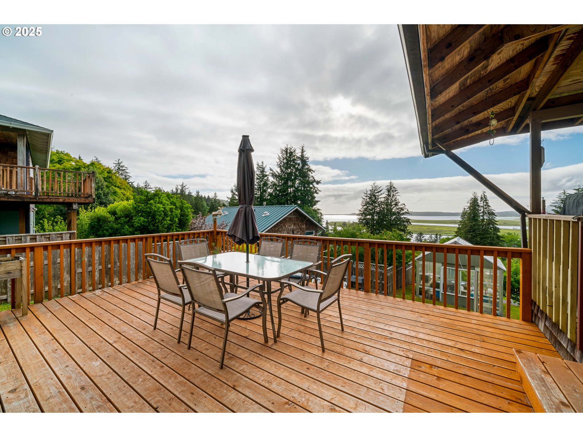 336 Gregory Street Wheeler, OR 97147 - Photo 37 of 42 a view of a deck with two chair and wooden floor