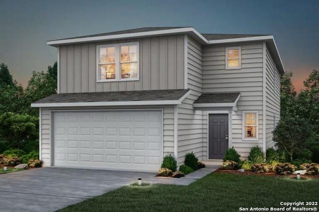 a front view of a house with a garden and garage