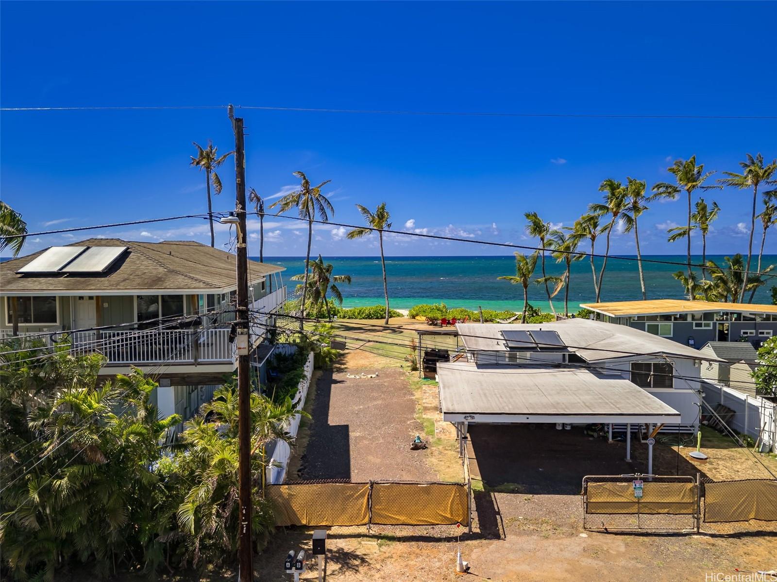 67-267 Kahaone Loop, Unit 2 Waialua, HI 96791 - Photo 19 of 20 a view of a patio with table and chairs potted plants