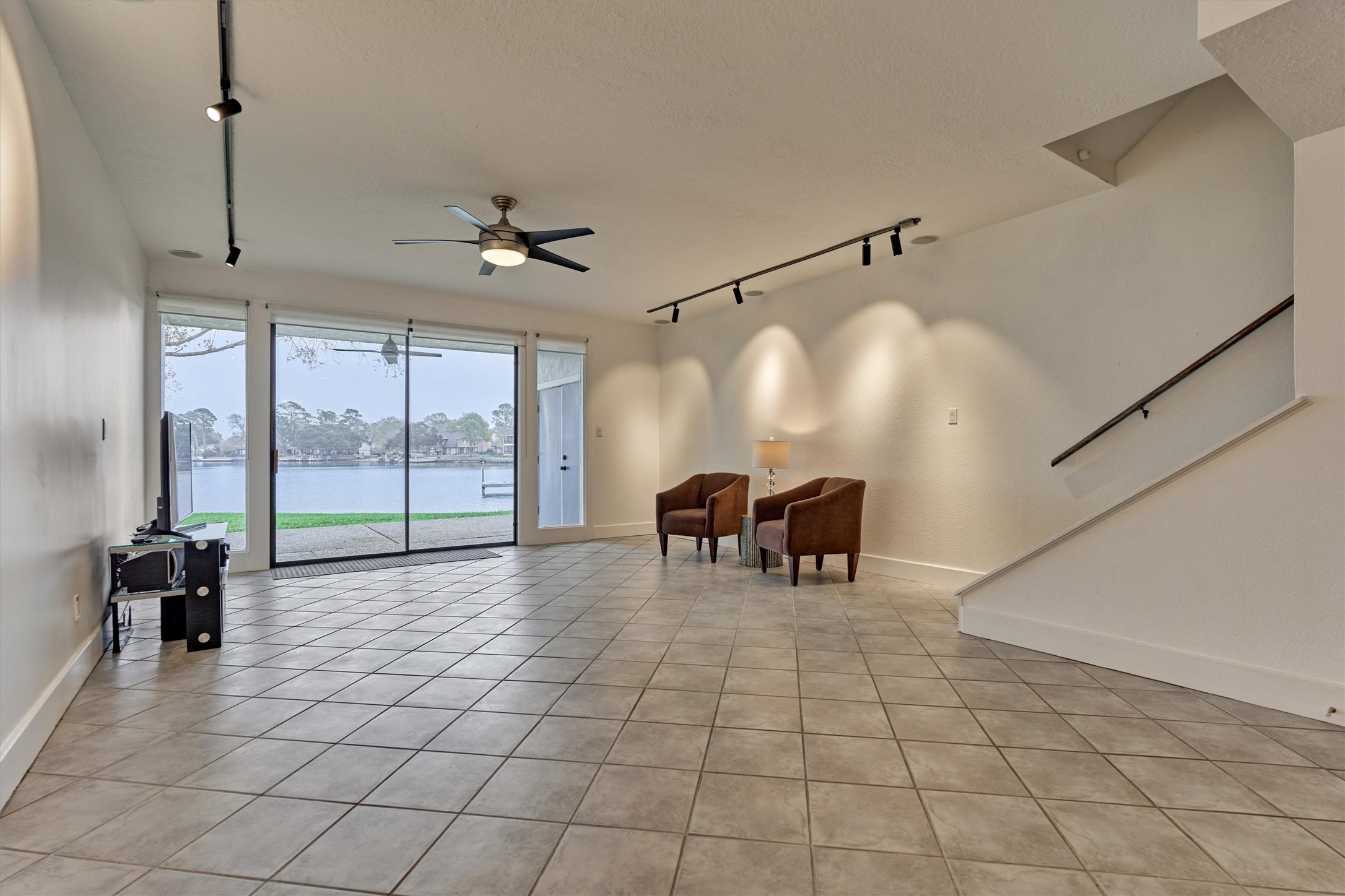 1427 Bowsprit Point Willis, TX 77318 - Photo 15 of 47 The living room features a large glass sliding door with sidelights for maximum views of the lake from the first floor.
