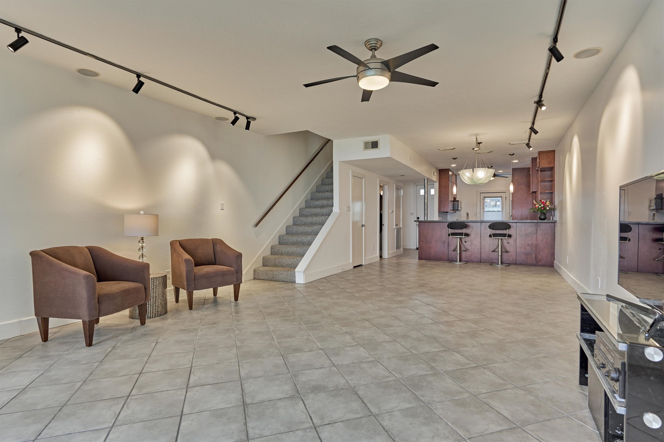 1427 Bowsprit Point Willis, TX 77318 - Photo 17 of 47 A look back at the living room, dining area and kitchen beyond. Under the stairs is a powder room and storage closet.