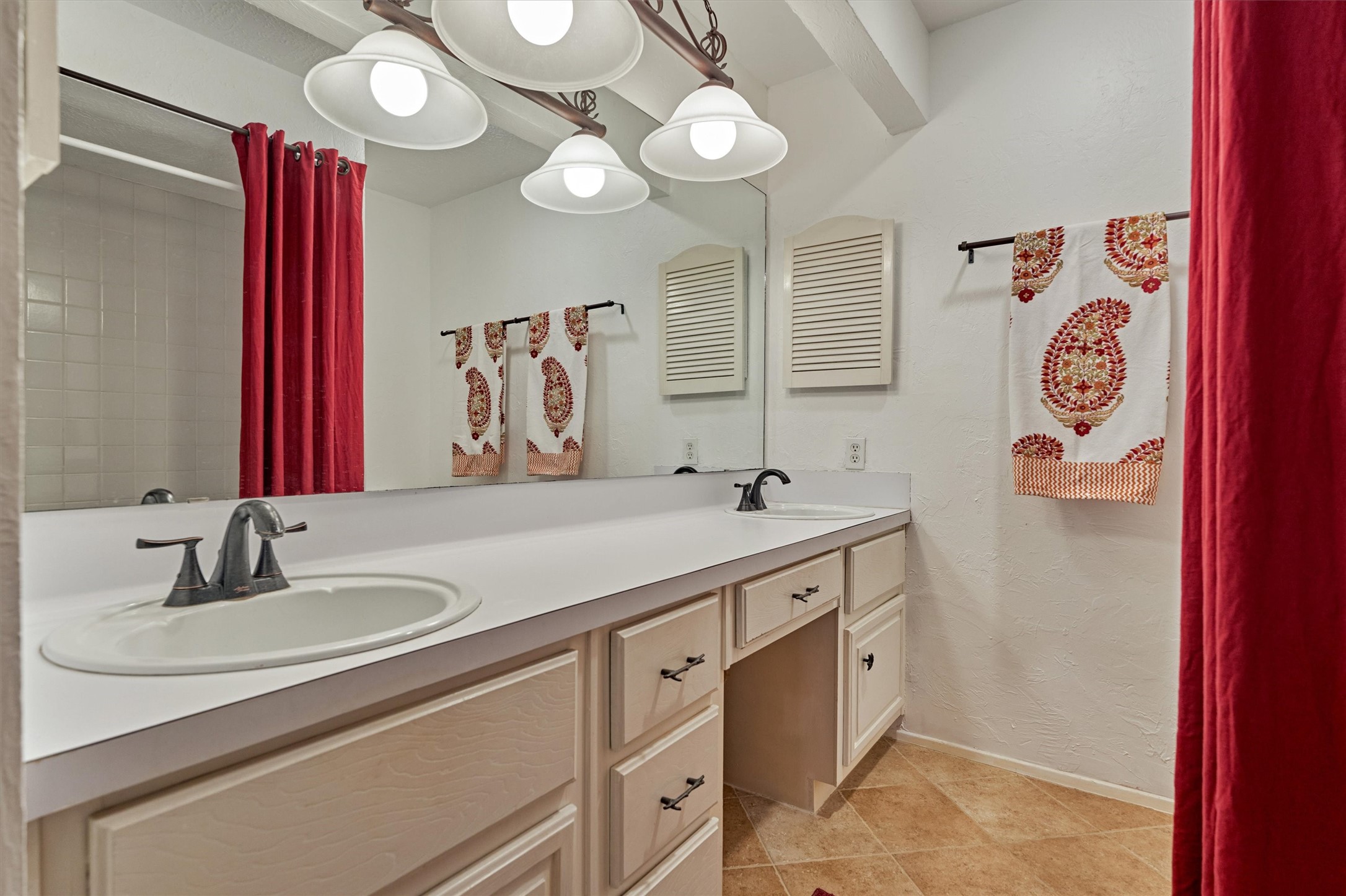 1427 Bowsprit Point Willis, TX 77318 - Photo 34 of 47 The primary ensuite bath offers double slinks, a vanity area, storage cabinets and drawers, and a bathtub with shower.