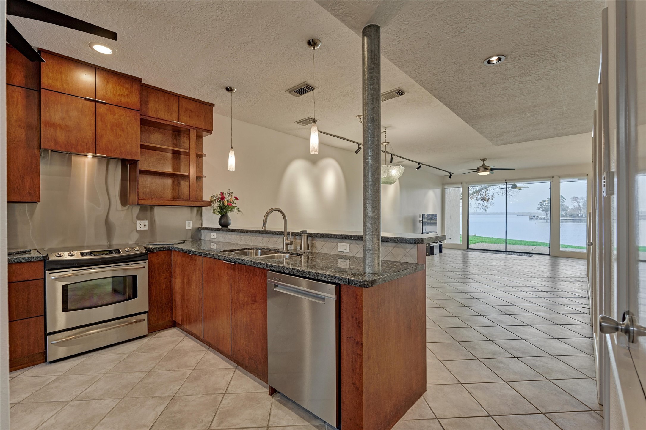 1427 Bowsprit Point Willis, TX 77318 - Photo 9 of 47 The first floor is an open concept living space for great family time and ease of entertaining. A view of the lake is immediately seen from the entry way!