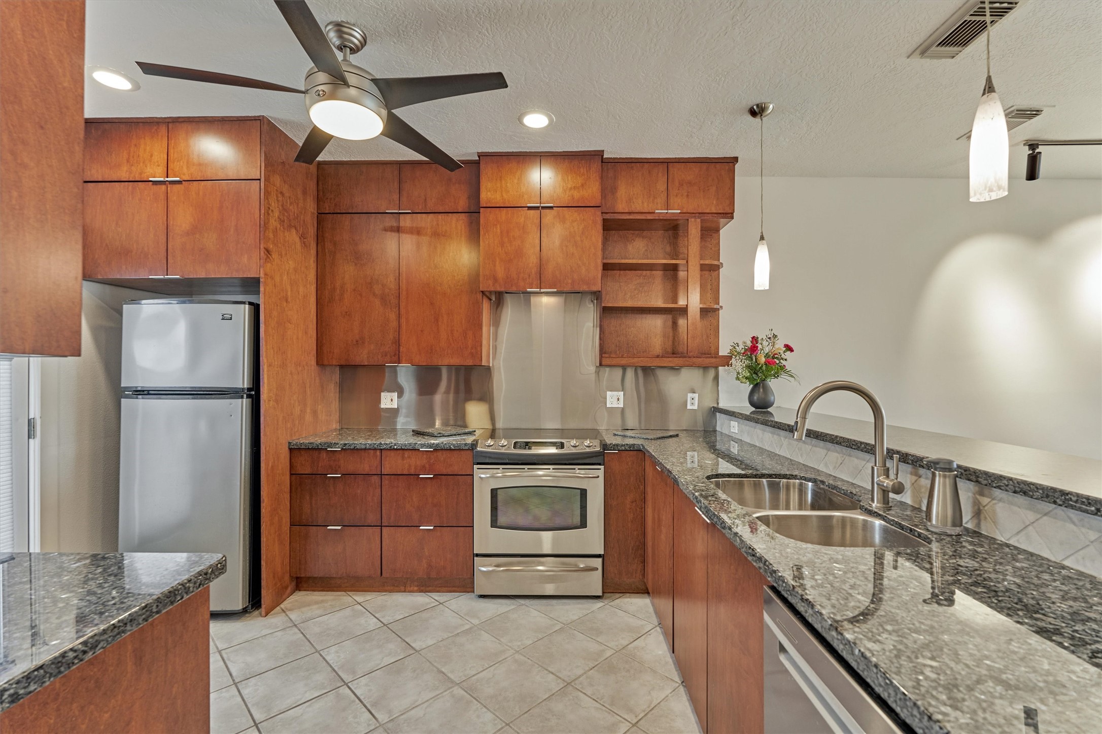 1427 Bowsprit Point Willis, TX 77318 - Photo 10 of 47 Custom built wood cabinetry and stainless backsplash provide a modern, classic style. The kitchen was redesigned to allow plenty of cabinet and counter space.