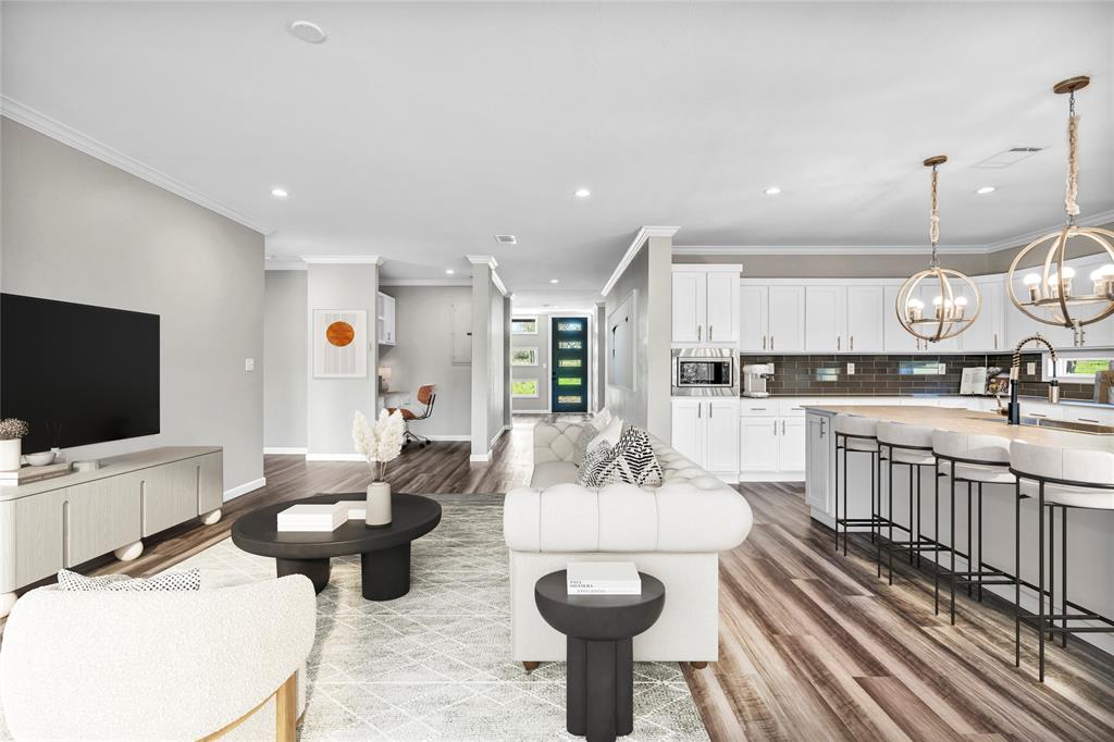 900 Chamberlin Road Dale, TX 78616 - Photo 2 of 14 a living room with furniture a flat screen tv and kitchen view