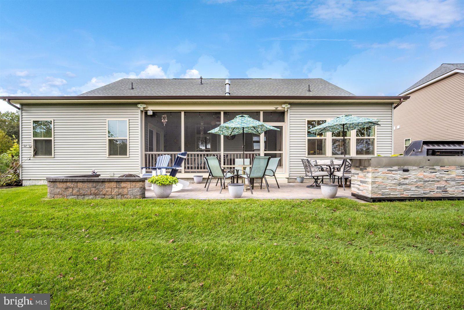 23546 Robalo Road Frankford, DE 19945 - Photo 11 of 78 a view of a house with patio and a garden