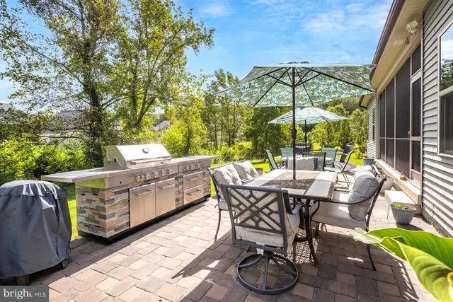 a living room with furniture a fireplace and a kitchen view