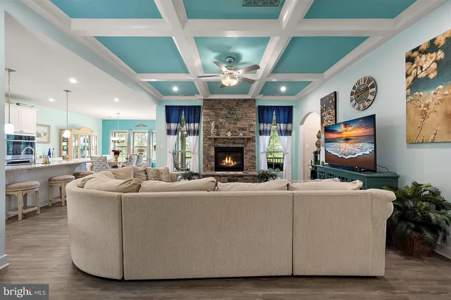 a kitchen with stainless steel appliances granite countertop a refrigerator a stove a sink dishwasher and a refrigerator with wooden floor