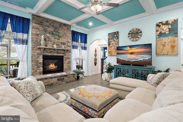 a kitchen with stainless steel appliances kitchen island granite countertop a table chairs sink and cabinets