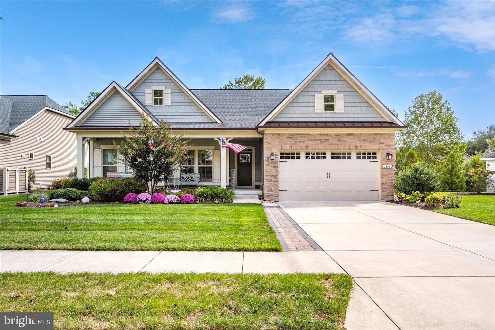 23546 Robalo Road Frankford, DE 19945 - Photo 3 of 78 a front view of a house with a yard and garage