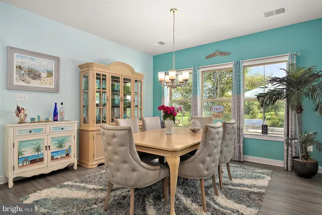 a living room with furniture a flat screen tv and a large window